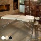Table de massage pliable en aluminium blanc avec réglage de hauteur et accoudoirs.