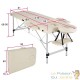 Table de massage pliable en aluminium beige avec réglage de hauteur et accoudoirs.