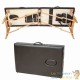 Table de massage noire pliable en bois avec réglage de hauteur et accoudoirs.